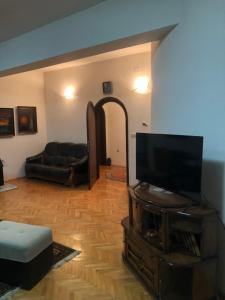 a living room with a flat screen tv and a couch at Marko and Mila apartment in Prilep