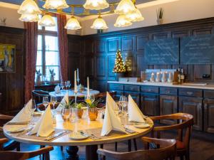 a dining room with a table with napkins on it at Dorint Am Goethepark Weimar in Weimar