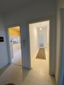 an empty room with two doors and a kitchen at Bardo centre in Tunis
