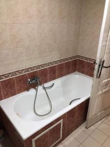a bath tub with a faucet in a bathroom at Bardo centre in Tunis