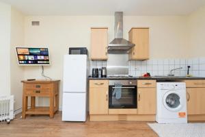 a kitchen with a white refrigerator and a washer at Chandlers Ford -1bedroom with free parking in Chandlers Ford +4 photos