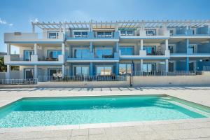 a building with a swimming pool in front of it at AffittaSardegna - Bilo Elicriso in Trinità dʼAgultu