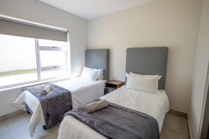 a bedroom with two beds and a window at Apartment 35 - 1 On York in George