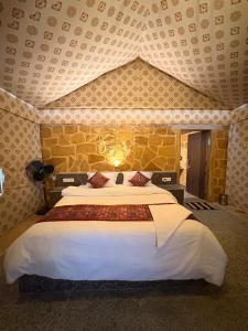 a bedroom with a large bed in a room at kalp desert camp in Jaisalmer