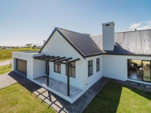 an overhead view of a white house with solar panels at Fifty1 on Long on Kingswood Golf Estate in George +30 photos