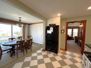 a kitchen and dining room with a table and a refrigerator at Lady Mary Angeline in Saint Ignace