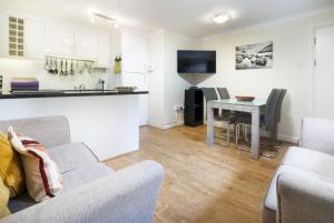 a living room with a couch and a table at The Screes Apartment - Short stroll from Wastwater in Nether Wasdale