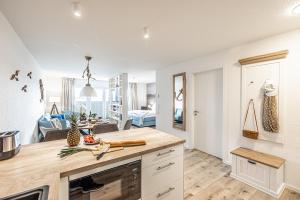 a kitchen with a counter top and a living room at Schlei-Koje 4 in Schleswig +28 photos