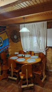 a room with a table and chairs and a window at Stara Khata Карпати in Sheshory +102 photos