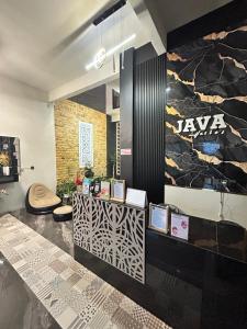 a lobby with a counter with a sign on the wall at Java Hostel 2 in Lumajang