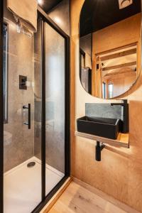 a bathroom with a shower and a mirror at Cabins at Bogee Farm in Saint Ervan