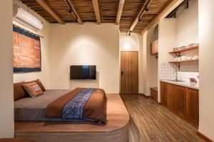 a bedroom with a bed and a television in a room at The Amber Lotus Hanoi-Elegant Stay with Free Pickup-Near Old Quarter in Hanoi
