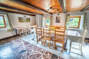 a dining room with a table and chairs at Charmante vieille ferme du Grand Père Prosper proche Gérardmer in Liézey