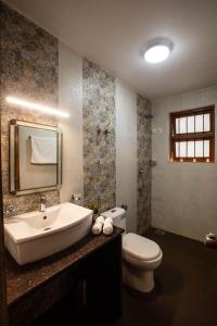 a bathroom with a sink and a toilet at Thor Villa, 5BHK-Private Pool-Cook-Caretaker in Assagao