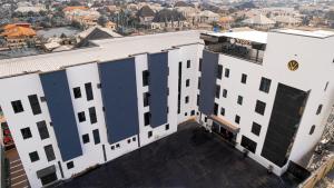 an overhead view of a white building with windows at Vizit Hotel & Suites in Benin City