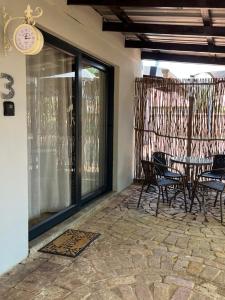 a patio with a table and chairs and a clock at 7 At Brainline in Pretoria