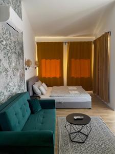 a living room with a couch and a bed at Riverside Apartment in Makó