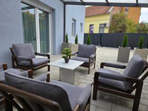 a patio with chairs and a table on a patio at Apartman Bugi Vukovar in Vukovar