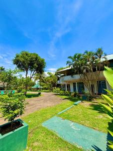 a resort with a yard with trees and a building at Tharindu Villa in Dankotuwa