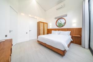 a bedroom with a large white bed and a dresser at Oasis Pandawa 10A - Private Luxury Awaits - Newly Built Villa with Pool in Ungasan +7 photos