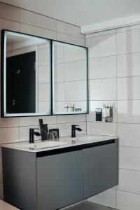 a bathroom with two sinks and a mirror at Grey Street Hotel in Newcastle upon Tyne