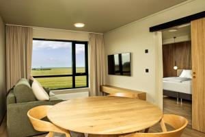 a living room with a table and a couch at Hotel Loa in Hvolsvöllur