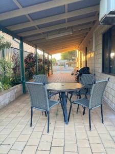 a patio table and chairs on a patio at Questro Lodge in Kalbarri