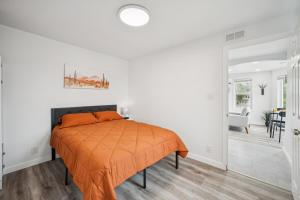 a bedroom with a bed with an orange blanket at ModPod 4 