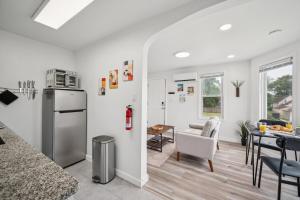 a kitchen and a living room with a table at ModPod 4 