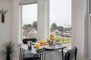 a table with a plate of food and glasses of orange juice at ModPod 4 