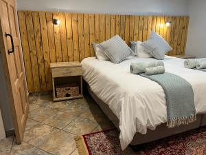 a bedroom with two beds and a wooden wall at 7 At Brainline in Pretoria