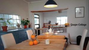 a kitchen with a wooden table with oranges on it at Quinta Cavaluz in Poceirão