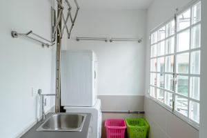 a kitchen with a sink and two baskets at Genesis Unique Comfy Loft - Spacious 5BR in Kota Kinabalu