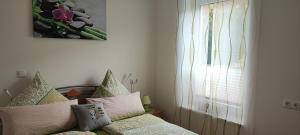 a room with a couch with pillows and a window at Ferien am Bergpark - Kassel, Bad Wilhelmshöhe in Kassel +27 photos