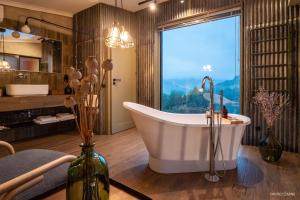 a bathroom with a tub and a large window at Dom w trawach in Ustrzyki Dolne +52 photos