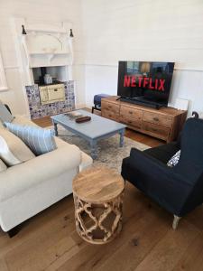 a living room with a couch and a table at CERULEAN HOUSE - Iconic Renovated Period Home - Close to Everything in Bendigo