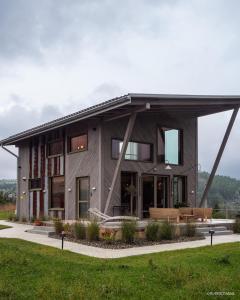 a large house with a gambrel roof at Dom w trawach in Ustrzyki Dolne