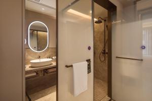 a bathroom with a sink and a mirror at Mercure Xi'an History Museum in Xi'an +52 photos