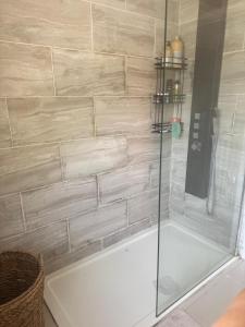 a shower with a glass door in a bathroom at Cozy home in peaceful home in Cheadle Hulme
