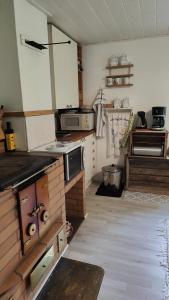 eine Küche mit einem Kochfeld im Zimmer in der Unterkunft Three cozy cottages, sauna and hot tub in Lohja