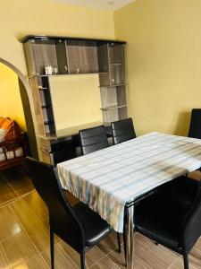 uma sala de jantar com uma mesa com cadeiras pretas em 3 Bedroom Own Compound em Melinde mais 6 fotografias