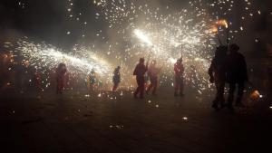 a group of people standing in front of fireworks at QEhome - confort, parking y cargador EV en el centro de Manresa in Manresa