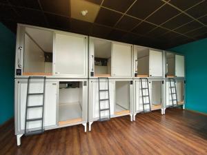 a room with white cabinets and ladders at Singer109 Hostel, Hotel & Apartment in Berlin