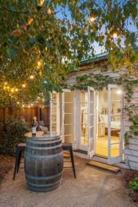 a wine barrel sitting in front of a tiny house at Studio Spring Hill Holiday Units Pet friendly in Point Lonsdale +16 photos