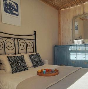 a bedroom with a bed with a tray of food on it at Quinta Cavaluz in Poceirão