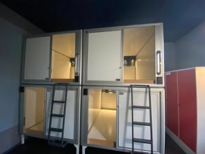 a cabinet with two ladders in a room at Singer109 Hostel, Hotel & Apartment in Berlin