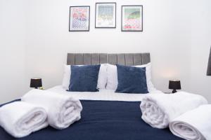 a bedroom with a bed with towels on it at Maple - Telford House - With Parking in Telford