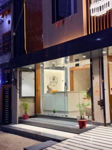 a store front with potted plants in the window at Hotel Kavita Inn in Ujjain