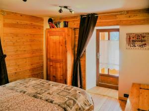 a bedroom with a bed and a window at Stone Cabin With Views Over Balme Valley in Ala di Stura