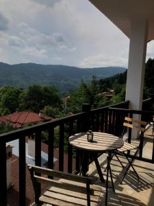 a table and chairs on a balcony with a view at Panorama Elati in Elati Trikalon